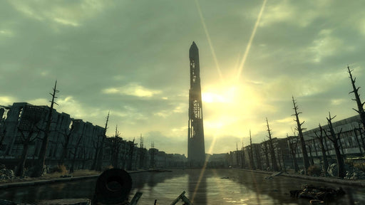 Gameplay Screenshot: The Washington Monument in Fallout 3, standing in the ruins of a destroyed city under an eerie sunset. Purchase Fallout 3 Game of the Year Edition for PC at RushGame.co