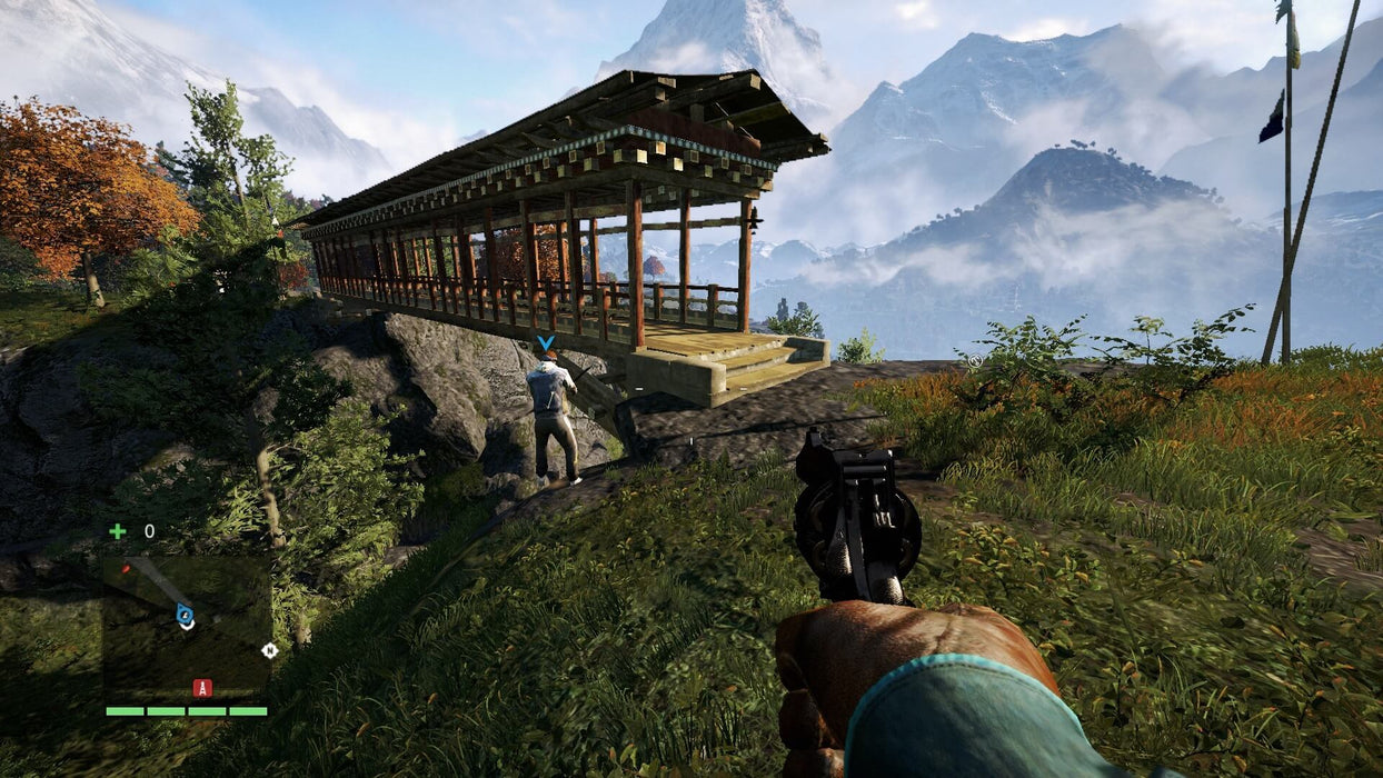 In-game screenshot from Far Cry 4 on PC, showing a first-person perspective aiming at an enemy near a traditional wooden bridge in a mountainous landscape. Get your Ubisoft Connect CD Key now at RushGame.co and experience action-packed open-world gameplay