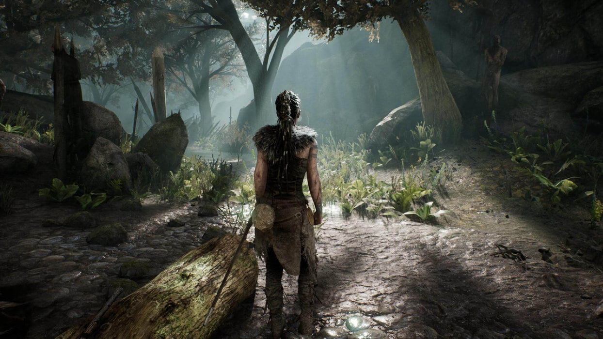 Hellblade: Senua's Sacrifice game screenshot - Senua navigating through a dense forest