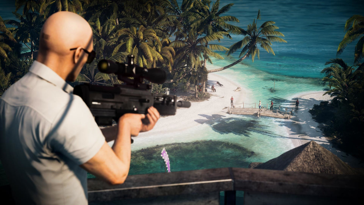 Hitman 2 - Agent 47 aiming with a sniper rifle towards a beach