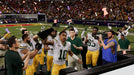 A victorious moment from Madden NFL 24 on EA Play, where the Green Bay Packers team celebrates their Super Bowl win with the iconic Vince Lombardi Trophy. Find Madden NFL 24 on EA Play at RushGame.co today