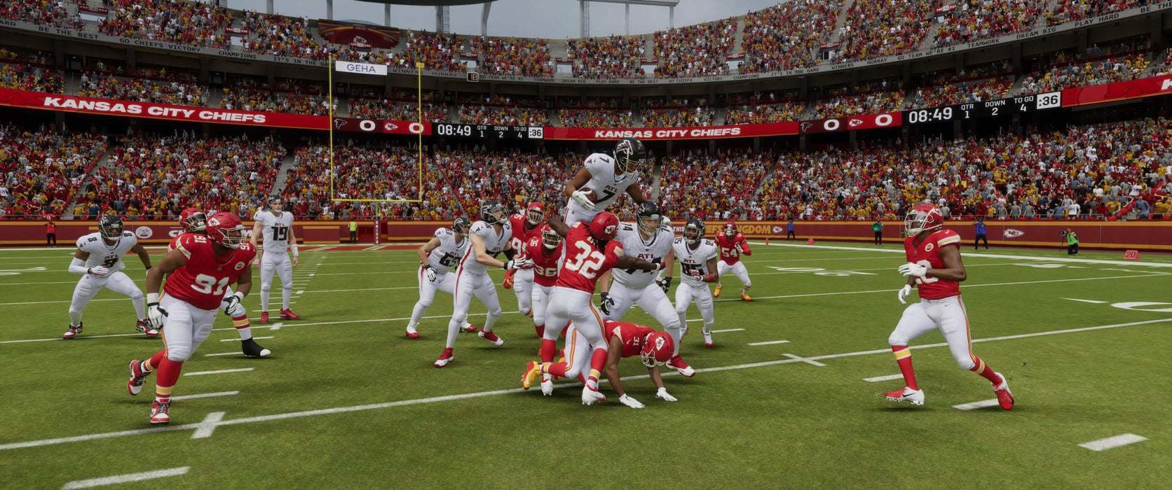 An intense action scene from Madden NFL 24 on EA Play, featuring a high-flying jump by an Atlanta Falcons player over the Kansas City Chiefs defense in the end zone. Buy Madden NFL 24 now at RushGame.co for EA Play and experience this action-packed gameplay.