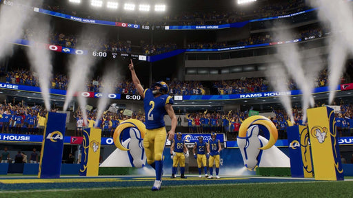 In-Game Screenshot 1 - Exciting entrance of Los Angeles Rams players in EA Sports Madden NFL 25 for PS5, with a packed stadium and intense atmosphere. Experience the thrill of professional football and get your Madden NFL 25 digital key at RushGame.co