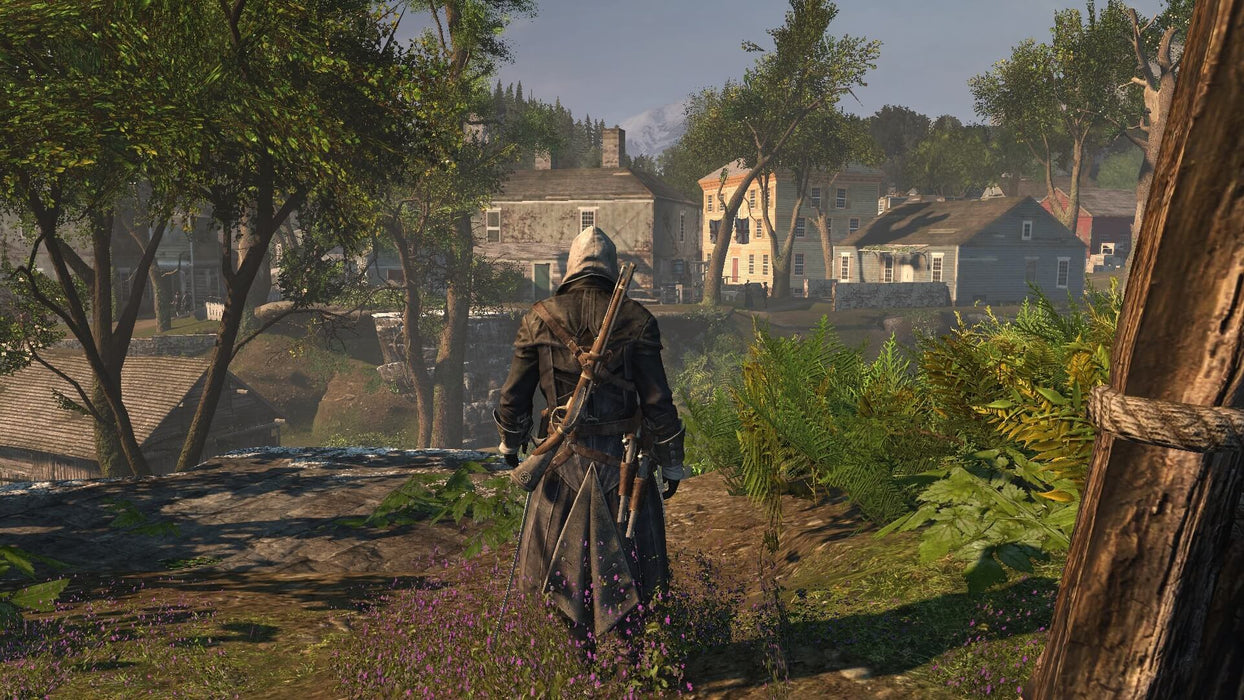 A hooded Shay Patrick Cormac observes a colonial-era village in Assassin's Creed Rogue Remastered on Xbox One. Explore the world of 18th-century America with your digital key from RushGame.co