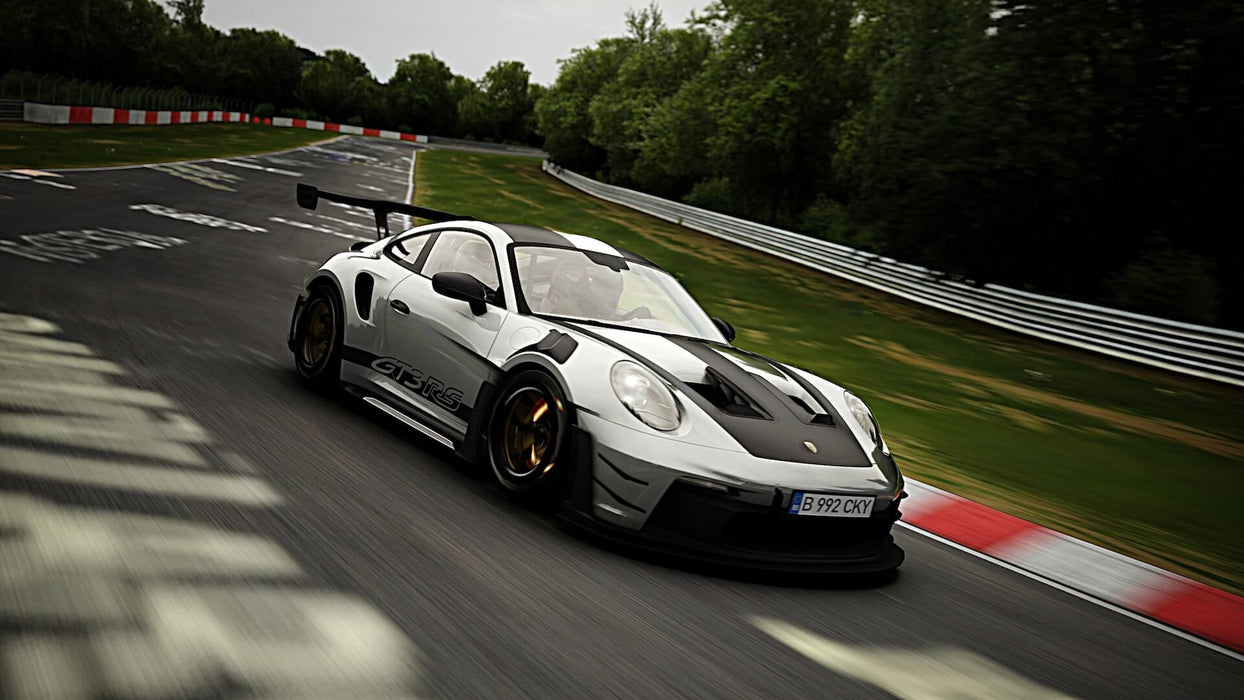  A silver and black Porsche 911 GT3 RS with an aggressive spoiler speeding through the Nürburgring corners. Feel the thrill of real racing in Assetto Corsa, available at RushGame.co!