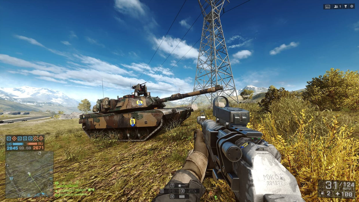 Battlefield 4 Xbox One Gameplay – Tank Warfare – A player holding a rifle near a heavy tank in an open field, with mountains and power lines in the background. A realistic battlefield experience in Battlefield 4, available at RushGame.co