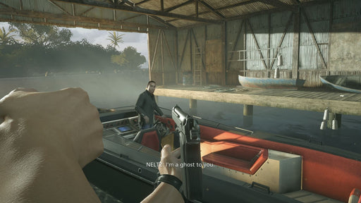 A first-person view of a player aiming a pistol at a suspect in a boat in Battlefield Hardline. The setting is a rustic dockside hideout with boats and wooden structures, reinforcing the police-vs-criminals gameplay theme