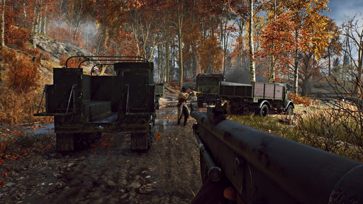 Battlefield V in-game screenshot – autumn forest battle – A soldier engages in combat in a dense autumn forest, firing at enemy trucks in Battlefield V. Experience immersive World War II battles—get your key now at RushGame.co