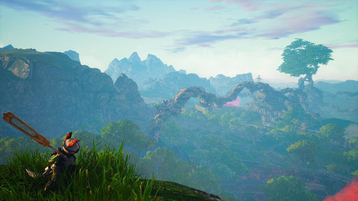 A scenic open-world view from Biomutant for Xbox One and Xbox Series X|S, featuring a small warrior character with a large blade resting on a grassy hill. The background showcases towering mountains, twisted tree roots forming a bridge, and lush vegetation under a pastel-colored sky. Available at RushGame.co