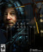 The cover art for Death Stranding on Steam, featuring Sam Porter Bridges in his dark hooded suit, illuminated by ambient lighting, alongside his floating mechanical companion. Buy the Death Stranding Steam CD Key at RushGame.co for instant digital delivery