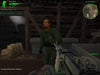 Gameplay screenshot: A mission scene from Delta Force: Xtreme showing the capture of an enemy target inside a wooden structure. The first-person shooter view includes a detailed M249 SAW machine gun. Tactical realism meets intense FPS action. Available as a digital Steam key on RushGame.co