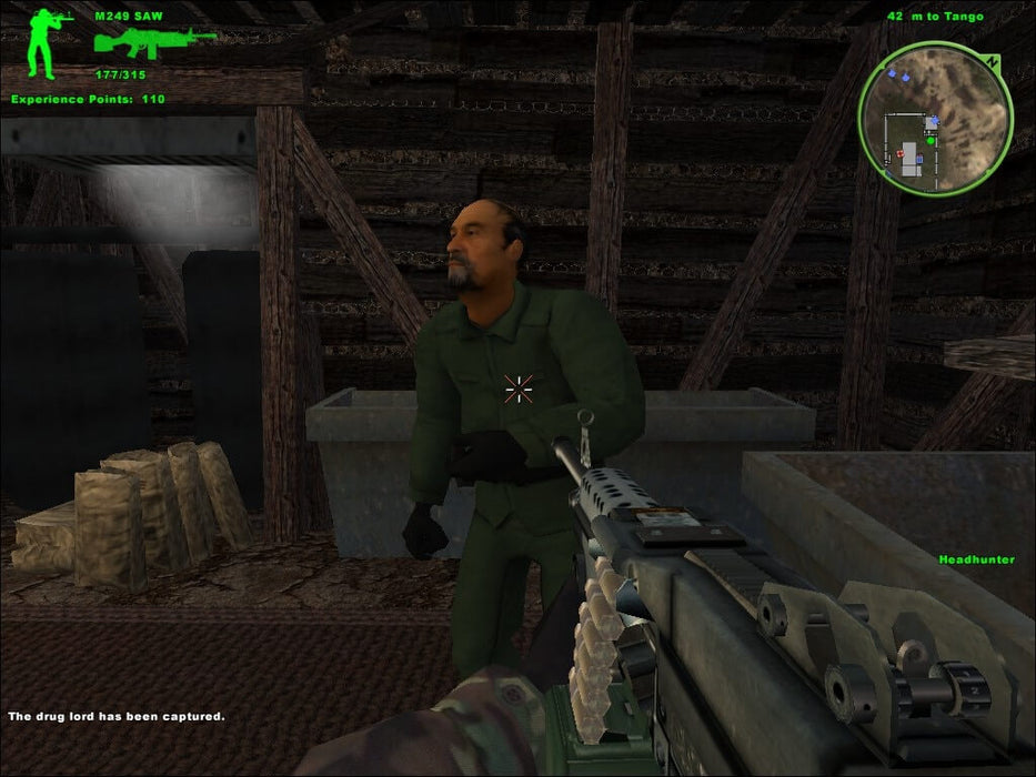 Gameplay screenshot: A mission scene from Delta Force: Xtreme showing the capture of an enemy target inside a wooden structure. The first-person shooter view includes a detailed M249 SAW machine gun. Tactical realism meets intense FPS action. Available as a digital Steam key on RushGame.co