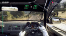 gameplay screenshot - First-person cockpit view from DiRT Rally 2.0, showing a driver gripping the steering wheel while navigating a winding road. The HUD provides navigation cues and race timing. Buy the game key for Steam at RushGame.co