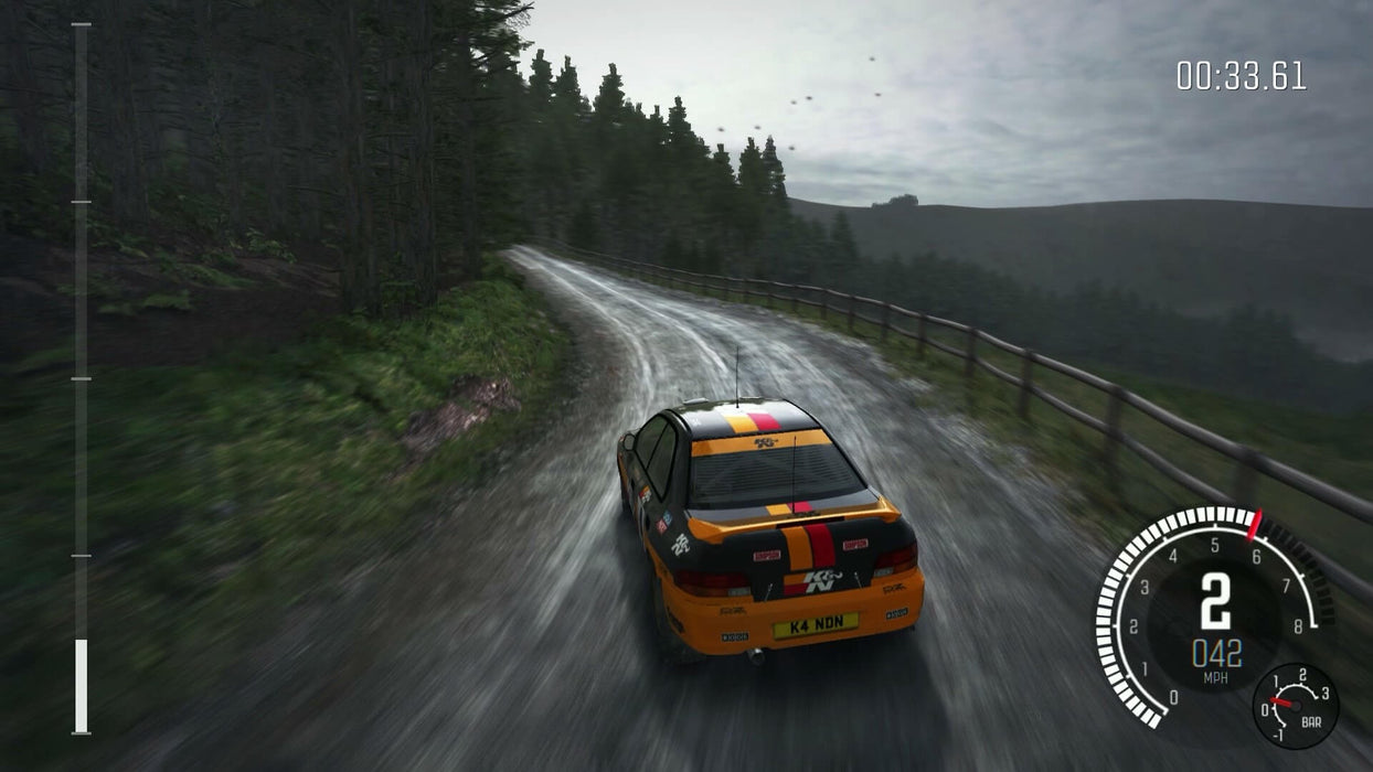 gameplay screenshot - A customized rally car speeds down a rain-soaked, narrow mountain road in DiRT Rally 2.0, with misty forests in the background. The speedometer and lap timer are displayed on the HUD. Purchase your digital key at RushGame.co