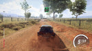 Gameplay screenshot - A rally car kicks up dust on a dirt road in DiRT Rally 2.0 as it speeds toward the finish line. The HUD displays the speedometer, lap time, and race position, with player names hovering over other competitors. Available now at RushGame.co