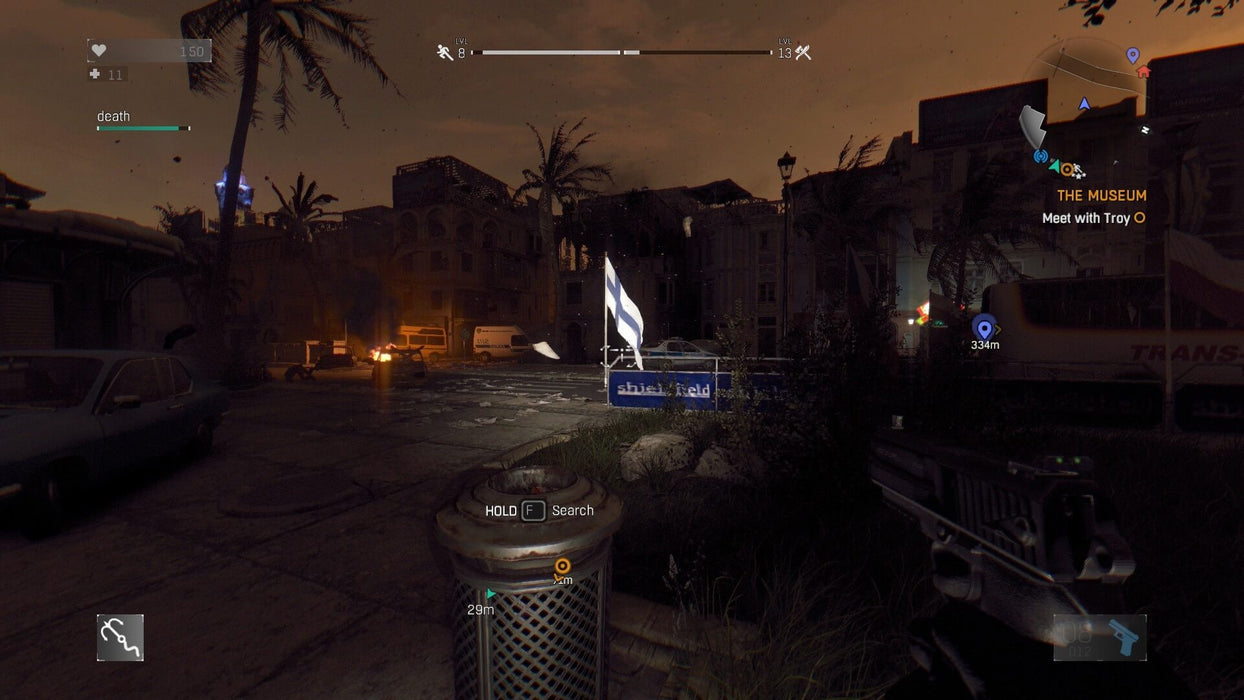 Gameplay screenshot - A tense nighttime scene in Dying Light: Definitive Edition, where a player wields a pistol in a dark, abandoned city street with burning cars and scattered debris. Experience heart-pounding zombie survival on Xbox One. Get your CD Key now at RushGame.co for instant digital delivery