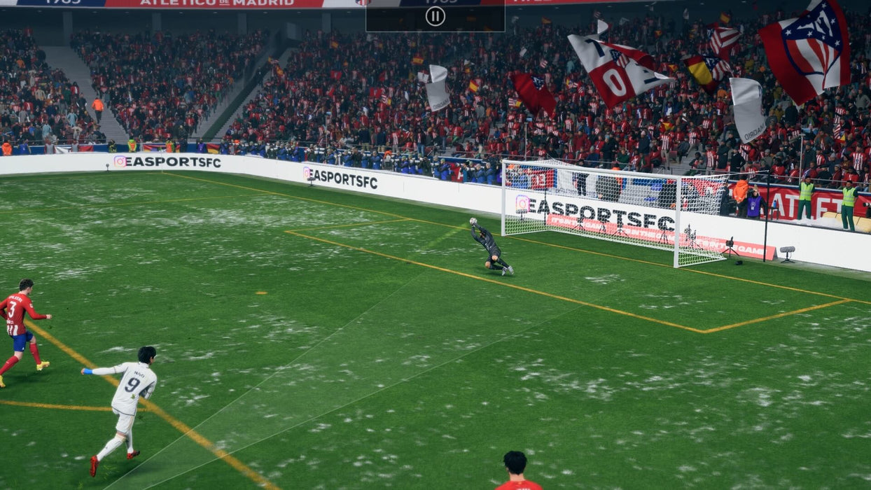 Gameplay scene from EA Sports FC 24 Ultimate Edition on Xbox One & Xbox Series X/S, featuring a snowy match between Atlético Madrid and Real Madrid. A player in a white jersey takes a shot on goal as the goalkeeper dives to save. Buy EA Sports FC 24 Ultimate Edition for Xbox at RushGame.co and experience next-gen football realism