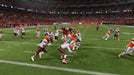 In-Game Screenshot - A high-impact moment in EA Sports Madden NFL 25 for Xbox, showcasing a Denver Broncos player leaping over Cleveland Browns defenders. Feel the intensity of the NFL with next-gen physics. Buy your Madden NFL 25 Xbox digital code at RushGame.co