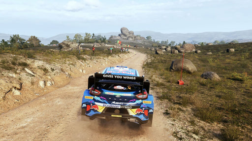 In-Game Screenshot 2 - A Ford rally car racing through a scenic yet challenging dirt road in EA Sports WRC 2023, with stunning visuals and immersive driving mechanics. Secure your EA Sports WRC 2023 PC CD Key at RushGame.co today for instant access