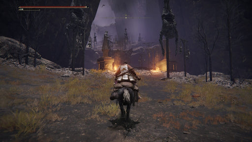 Gameplay Screenshot - A lone warrior on horseback enters a cursed valley in Elden Ring Deluxe Edition on Steam, surrounded by eerie gallows and burning torches. Get your digital key now at RushGame.co.