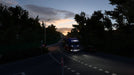 Gameplay screen - Evening highway scene from Euro Truck Simulator 2 Gold Bundle, where a brightly lit truck travels through a darkened forest road. The expansion offers stunning night-time trucking with realistic traffic and environments. Purchase Euro Truck Simulator 2 Gold Bundle PC Steam CD Key at RushGame.co and enjoy an enhanced trucking adventure