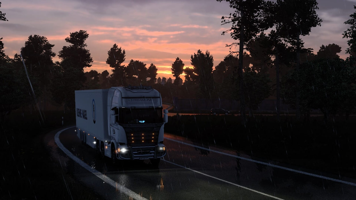 Gameplay screenshot - A rainy evening drive in Euro Truck Simulator 2, where a truck navigates wet roads under a dramatic sunset. Enjoy an authentic truck driving simulation with dynamic weather effects. Secure your Euro Truck Simulator 2 GOTY Edition PC Steam CD Key today at RushGame.co and start your journey