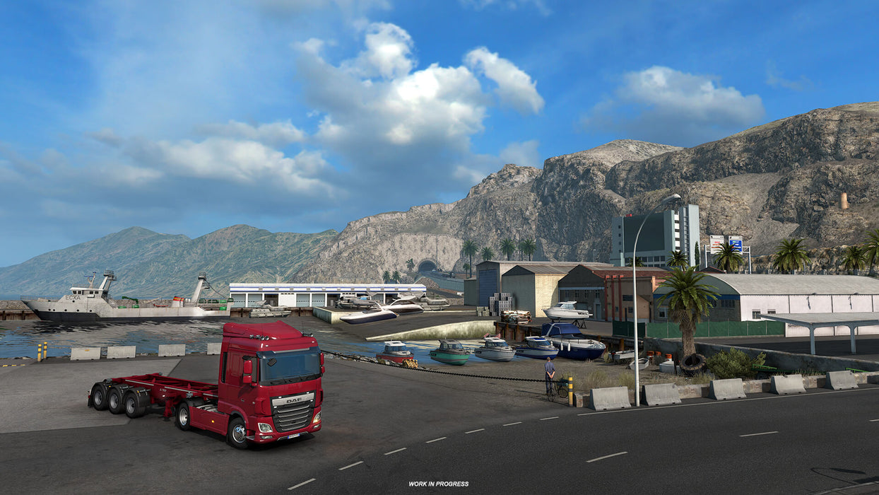 Screenshot from Euro Truck Simulator 2 - Iberia DLC, capturing a stunning coastal scene with a red DAF truck parked near a harbor. Mountains and yachts line the background, highlighting the diverse landscapes of Iberia. Purchase Euro Truck Simulator 2 - Iberia DLC PC Steam CD Key at RushGame.co and experience breathtaking routes across the Iberian Peninsula