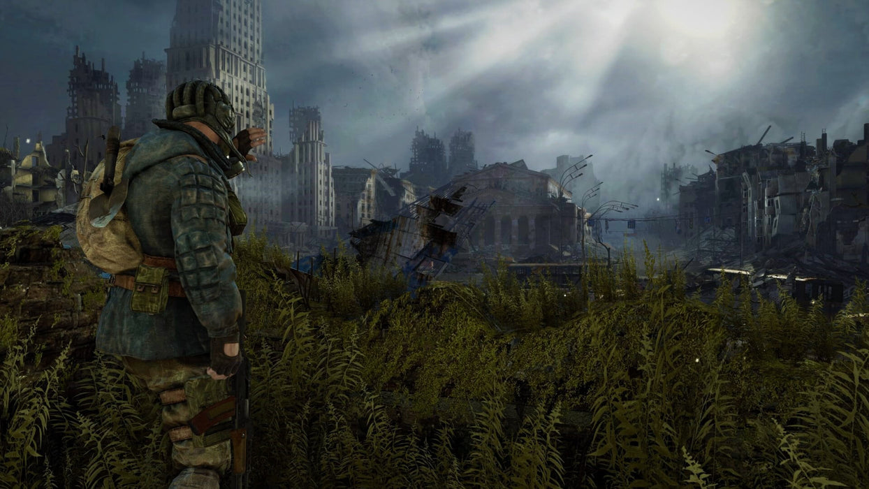 Character standing amidst overgrown vegetation and the ruins of a city bathed in sunlight in Metro Last Light Redux Steam code. Purchase the game for PC Steam at RushGame.co