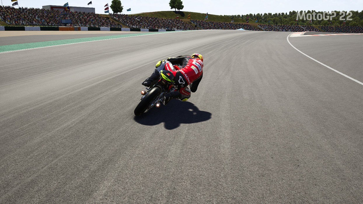 MotoGP 22 PC Game Racing Scene – A lone rider accelerates down a long stretch of track during a race in MotoGP 22, with a full crowd watching in the background. Purchase MotoGP 22 for PC on Steam from RushGame.co