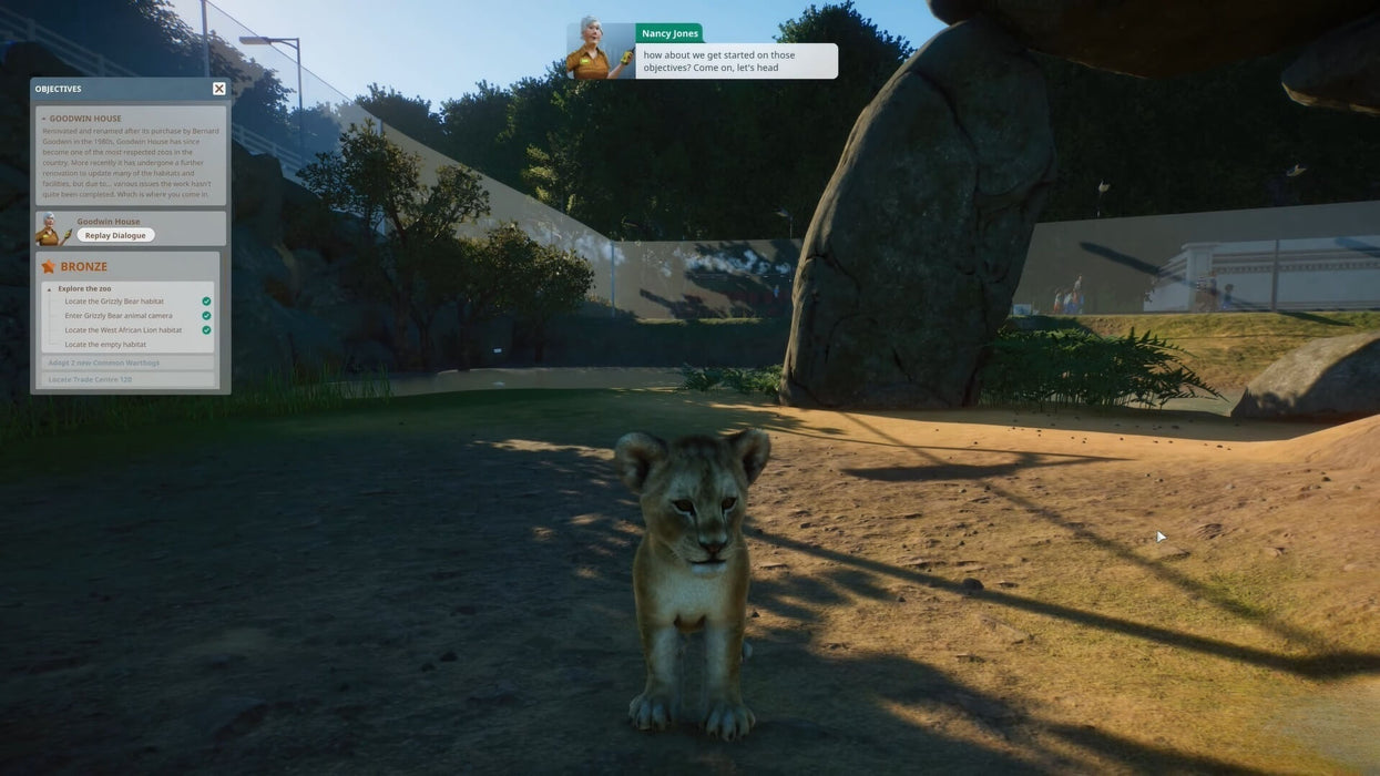 Close-up of a lion cub in a detailed exhibit from Planet Zoo Deluxe Edition on Steam, capturing the game's lifelike animal animations — available now at RushGame.co