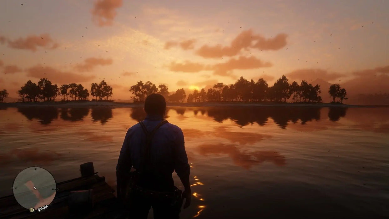 Beautiful sunset scene in Red Dead Redemption 2 on Xbox, showing the main character gazing over a tranquil lake. Buy your Xbox Series X|S digital CD key now at RushGame.co and experience breathtaking open-world gameplay