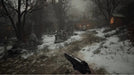 In-game screenshot from Resident Evil Village showing a snowy graveyard path and pistol in hand. Buy Resident Evil Village Xbox Series X|S CD Key now at RushGame.co for instant digital delivery