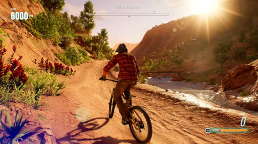 Beautiful Riders Republic gameplay image on PC, with a mountain biker pausing to enjoy the stunning sunset over Zion's picturesque Echo Canyon. Unlock your game with RushGame.co today