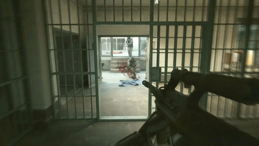 Screenshot from Robocop: Rogue City Alex Murphy Edition, showing a first-person view of Robocop engaging enemies inside a prison cell block. Purchase Robocop: Rogue City Alex Murphy Edition Steam game code at RushGame.co for fast digital delivery