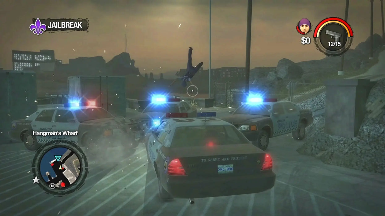 Saints Row 2 action scene with police cars, flashing lights, and chaos during a jailbreak mission at Hangman's Wharf. Unlock Saints Row 2 GOG CD Key from RushGame.co for fast access to this classic crime-filled adventure