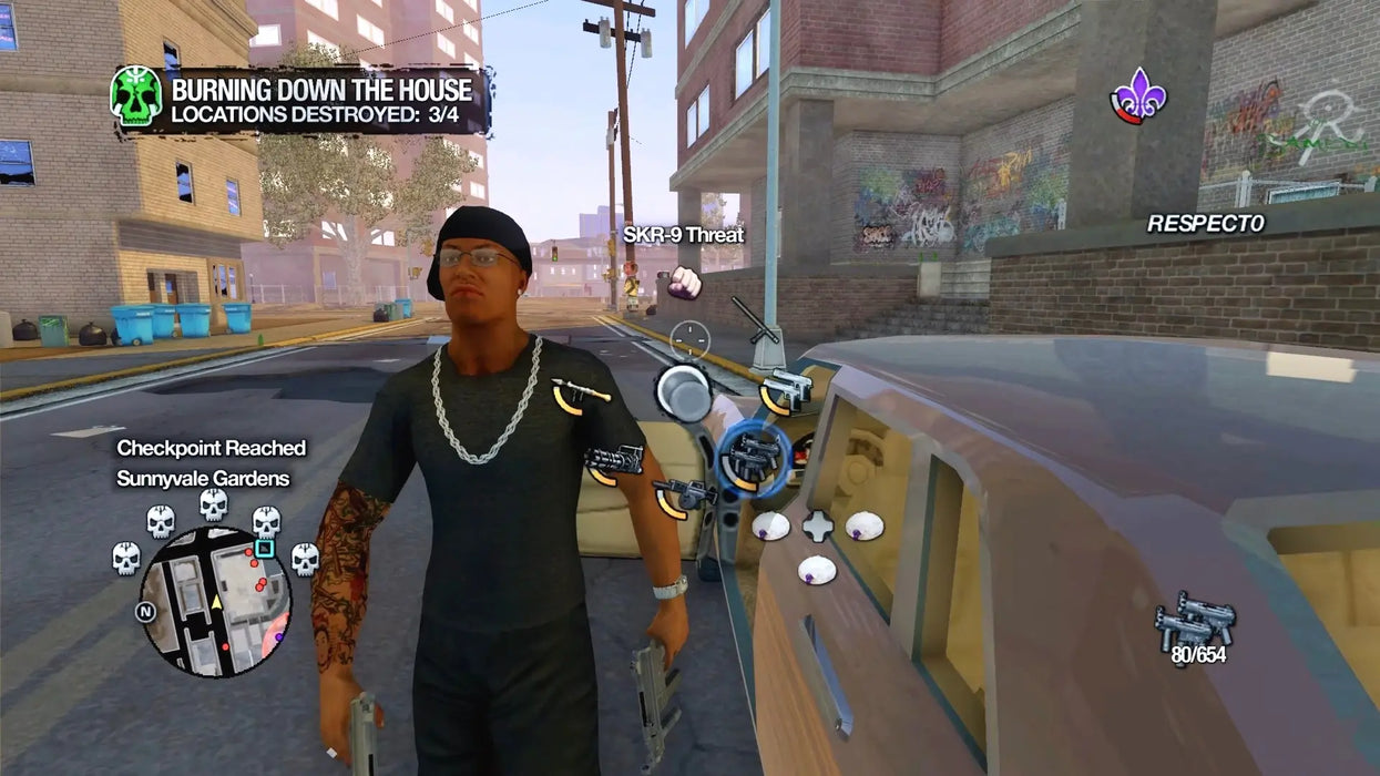 In-game screenshot from Saints Row 2 Steam version, showing the player character in a street scene with weapon selection wheel open. Buy Saints Row 2 Steam Key at RushGame.co and experience action-packed open-world gameplay with instant code delivery