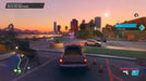 In-game screenshot from Saints Row on Steam, featuring a pickup truck driving along a waterfront boulevard at sunset, with a city skyline and mountains in the background. Buy your Saints Row Steam game key instantly at RushGame.co
