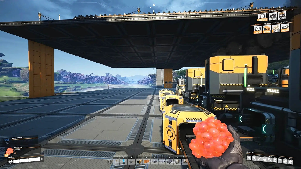 First-person perspective from Satisfactory on Steam, featuring the player holding a cluster of berries in a high-tech industrial zone with yellow machines and large platforms. Buy your digital Satisfactory Steam game key today at RushGame.co.