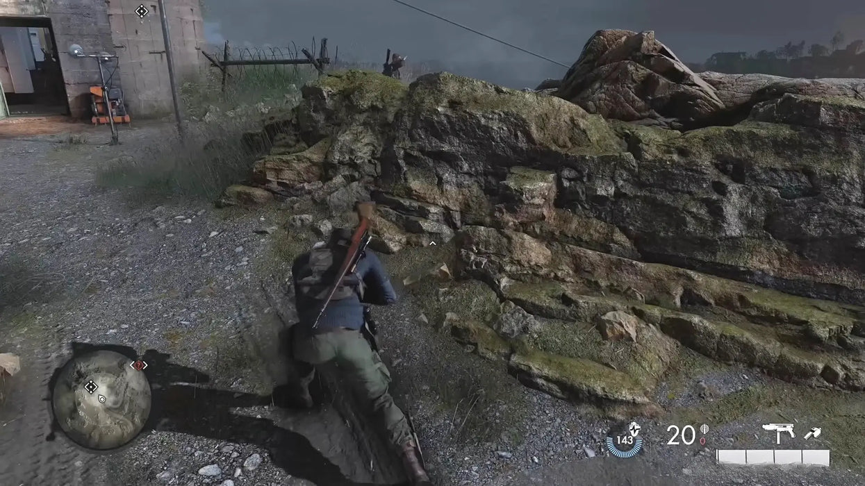 Sniper Elite 5 Season Pass One Xbox One gameplay with the player character crawling near rocky terrain during a stealth mission. Unlock your Xbox digital code at RushGame.co