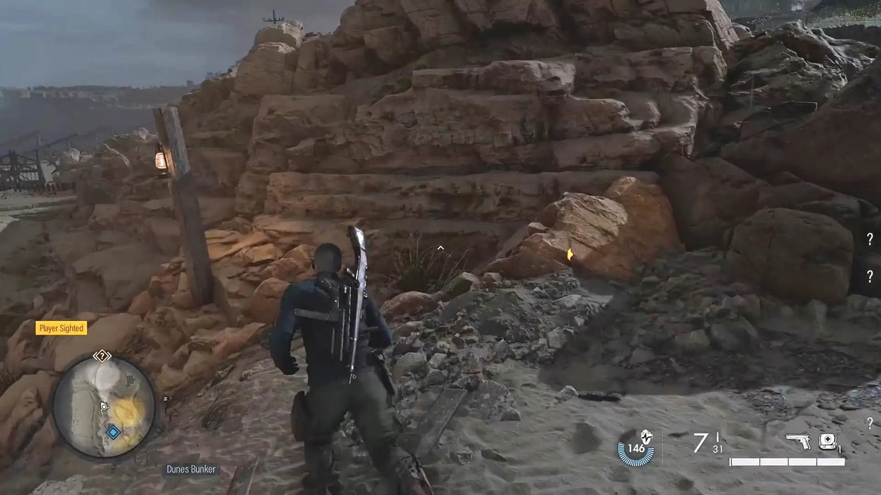 Sniper Elite 5 Steam gameplay showing the protagonist advancing through rugged terrain and rocky cliffs on a mission. Unlock Sniper Elite 5 with a Steam CD key from RushGame.co for immediate code delivery and intense stealth action