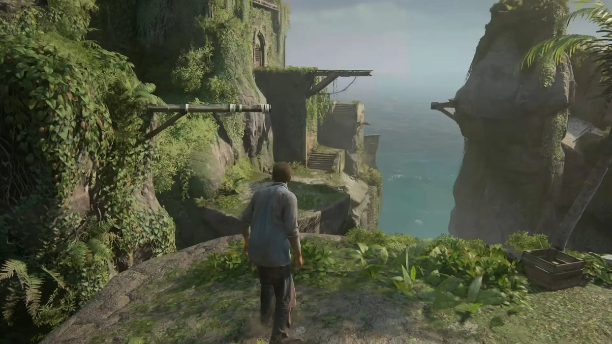 Player explores ancient ruins on a cliffside with breathtaking ocean views in Uncharted: Legacy of Thieves Collection. Purchase your Steam key at RushGame.co and uncover lost secrets in stunning environments